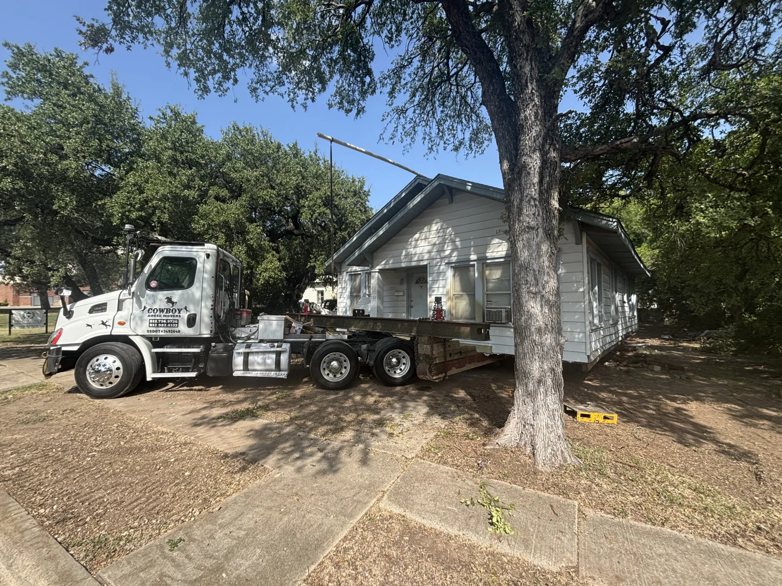 Cowboy House Movers preparing a pier-and-beam house at its original site