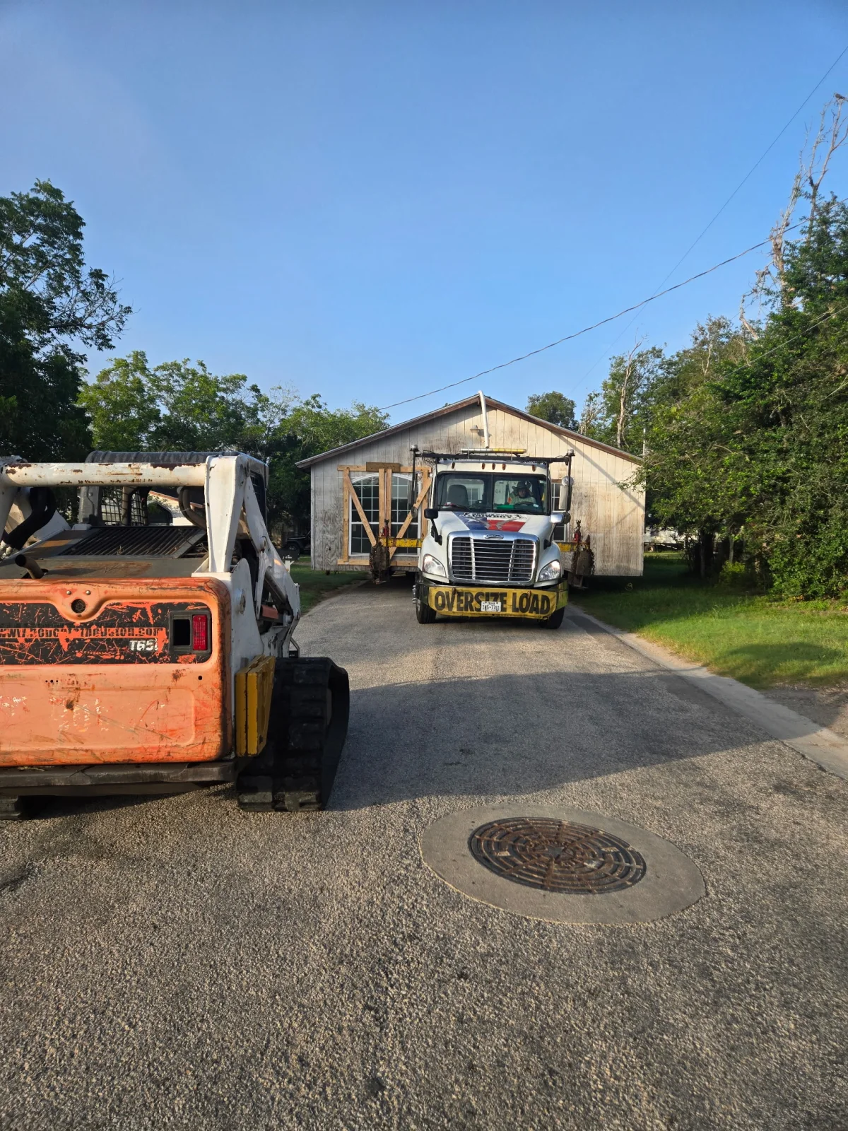 Cowboy House Movers moving a portable structure through a neighborhood