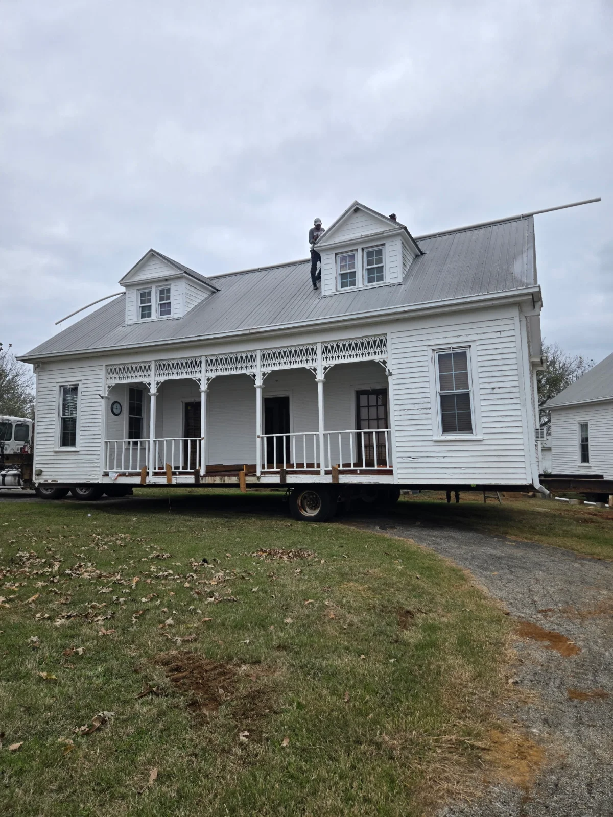 A white Victorian house loaded and ready to move